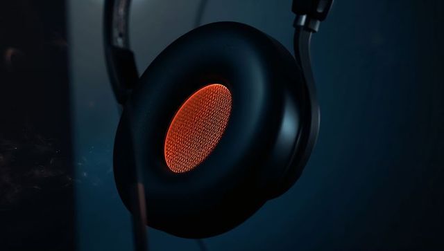 Glowing over-ear headphone earcup featuring orange mesh, sleek dark blue mood lighting
