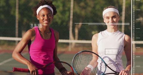 Diverse female tennis players on outdoor court at sunset