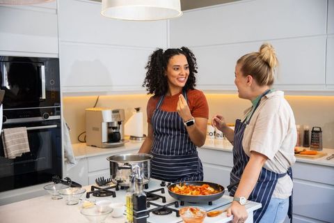 Diverse Female Friends Cooking and Chatting in Modern Kitchen