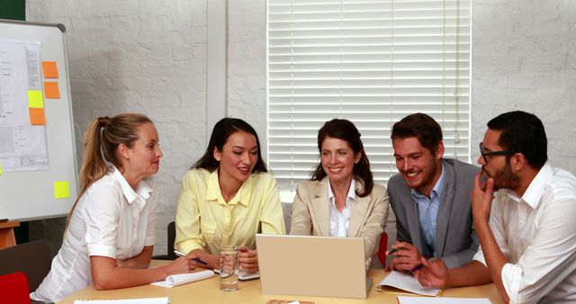 Team collaborating on project at office table - Download Free Stock Images Pikwizard.com