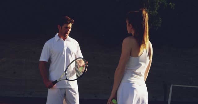 Tennis Coach Giving Instructions to Young Woman on Court - Download Free Stock Images Pikwizard.com