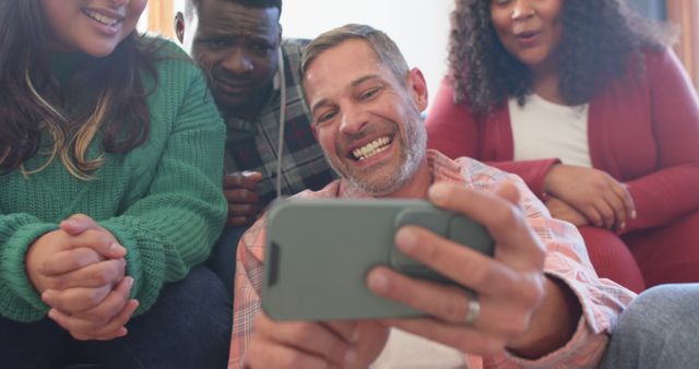 Group of Friends Laughing Together While Sharing a Mobile - Download Free Stock Images Pikwizard.com