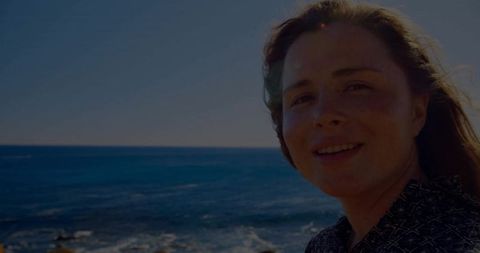 Smiling woman by ocean horizon