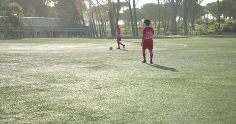 Teen Soccer Players Celebrating Goal on School Field