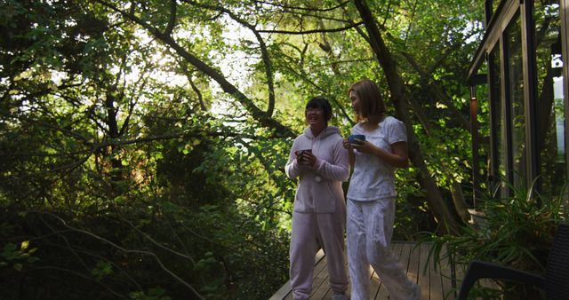 Friends Enjoying Morning Coffee on Balcony Surrounded by Trees - Download Free Stock Images Pikwizard.com