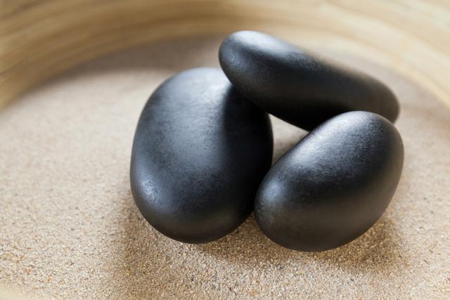 Three pebble stones on a sand - Download Free Stock Photos Pikwizard.com