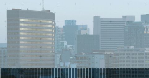 Hazy Urban Skyline with Illuminated Corporate High-rises