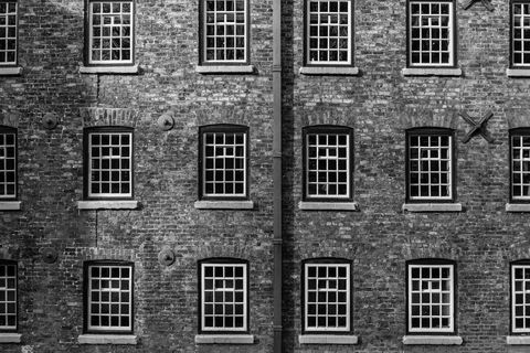 Historic brick building with symmetrical windows in black and white