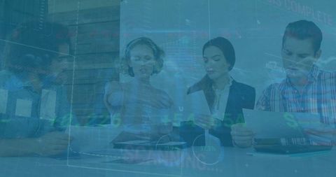 Business team analyzing financial reports and stock data in meeting