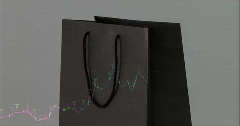 Matte black shopping bags with rope handles and financial candlestick chart overlay