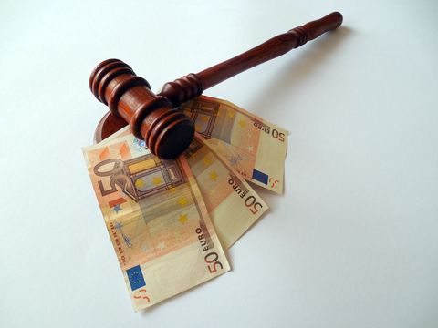 Euro Banknotes with Wooden Gavel on White Background