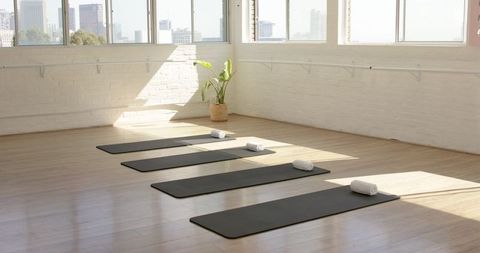 Bright Yoga Studio with Sunlit Mats and Towels for Class - Download Free Stock Images Pikwizard.com