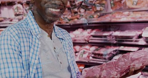 Smiling shopper holding vacuum-sealed meat in grocery store aisle