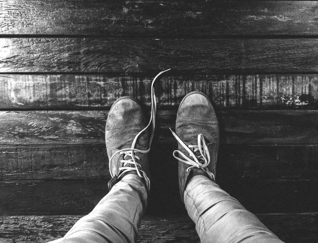 Worn Boots with Untied Laces on Wooden Floor - Download Free Stock Photos Pikwizard.com