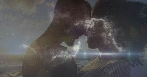 Silhouetted Couple Touching Foreheads Double Exposure Nebula Over Ocean Dusk