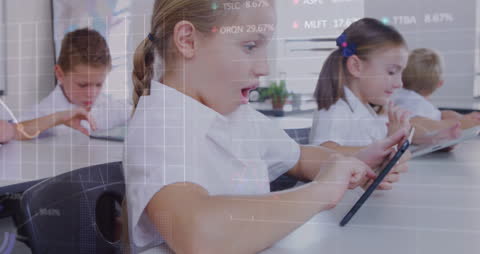 Schoolchildren Engaged with Tablet Technology in Classroom
