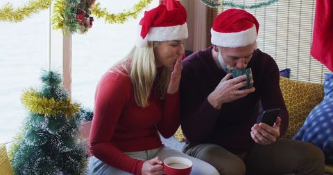 Couple Video Calling During Festive Christmas Celebration Indoors