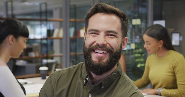 Smiling Man with Beard in Modern Office Working - Download Free Stock Images Pikwizard.com