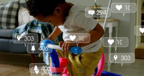 Toddler enjoying ride-on toy with social media elements