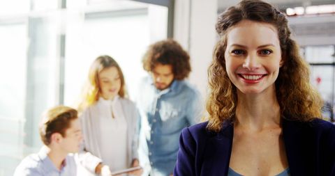 Confident Businesswoman Leading Collaborative Team in Modern Office