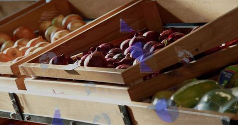 Wooden crates displaying red onions and yellow onions on angled market produce shelves