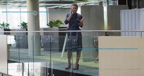 Businesswoman in Modern Office Discussing via Smartphone