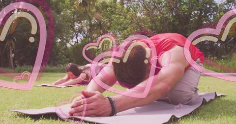 Couple practicing yoga outdoors for serenity in nature