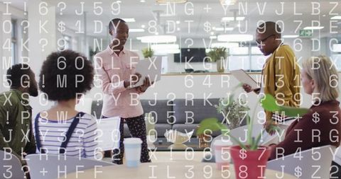 Diverse Team Collaborating in Open-Plan Office While Presenting Data and Live Code Review