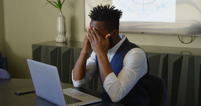 Stressed Businessman with Laptop in Office Environment - Download Free Stock Images Pikwizard.com