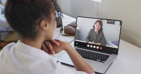 Businesswoman Engaged in Virtual Video Call at Modern Workspace