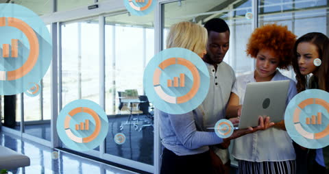 Diverse Team Analyzing Laptop Data with Graph Overlay in Modern Office