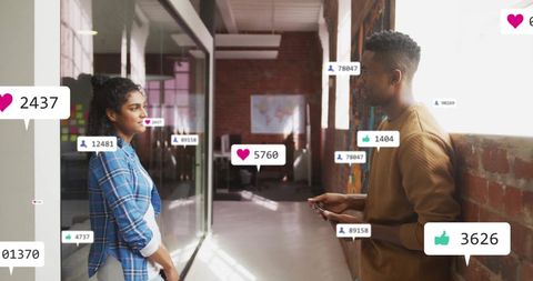 Colleagues Engaging in Digital Media Networking at Modern Workplace