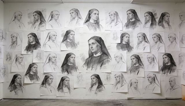 Charcoal nun portrait studies covering studio wall with central detailed portrait