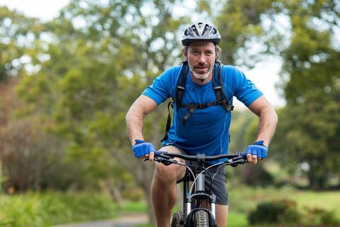 Enthusiastic Middle-Aged Cyclist Experiencing Outdoor Adventure on Mountain Bike