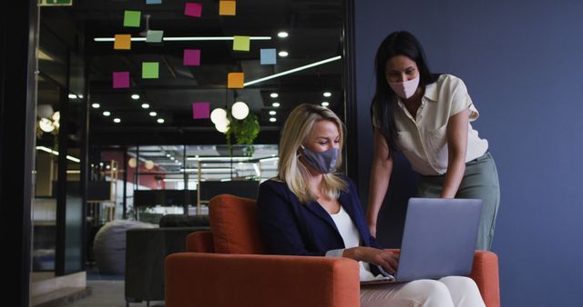 Businesswomen Collaborating on Laptop in Modern Office with Sticky Notes - Download Free Stock Images Pikwizard.com