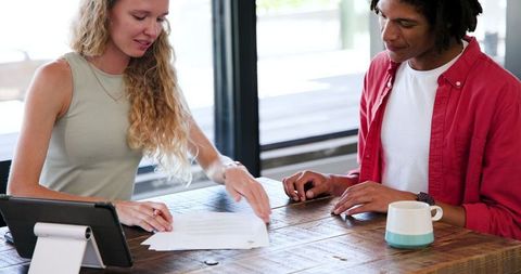 Colleagues Analyzing Documents in Office Meeting