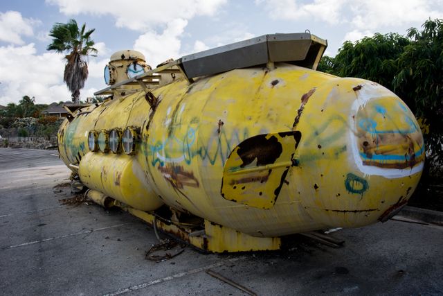 Abandoned Yellow Submarine with Graffiti Under Cloudy Sky - Download Free Stock Images Pikwizard.com