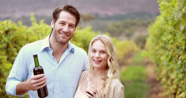 A Caucasian couple enjoys a wine tasting experience in a vineyard, with copy space. Their smiles and the vineyard backdrop suggest a leisurely and romantic outing.