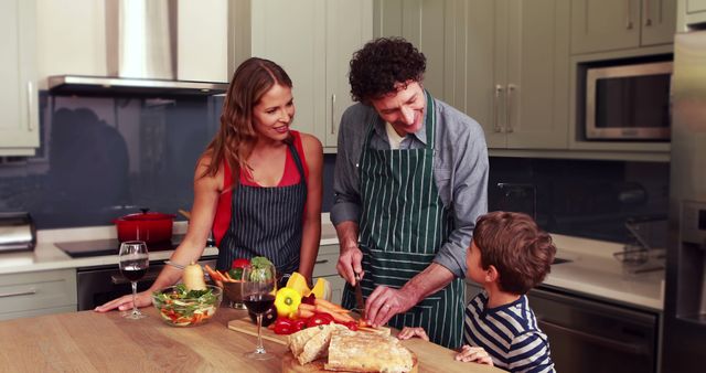 Image shows cheerful family engaged in preparing fresh vegetables in a well-organized home kitchen. The parents and their children are smiling, actively participating, and working together as a team. This scene represents family bonding, healthy eating, and the joy of domestic life. Ideal for websites and campaigns focused on family activities, healthy lifestyles, home cooking, and kitchen products.