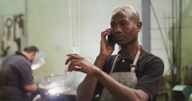 Industrial Worker Talking on Smartphone in Factory - Download Free Stock Images Pikwizard.com