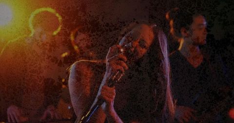 Energetic concert with female vocalist and musicians on stage