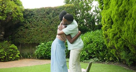 Couple Sharing Joyful Hug in Tranquil Garden Setting