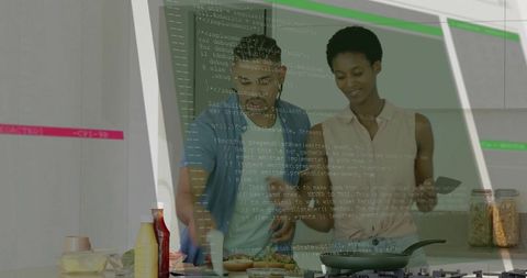 Young couple cooking with smartphone guidance spreading sauce on bread in modern kitchen