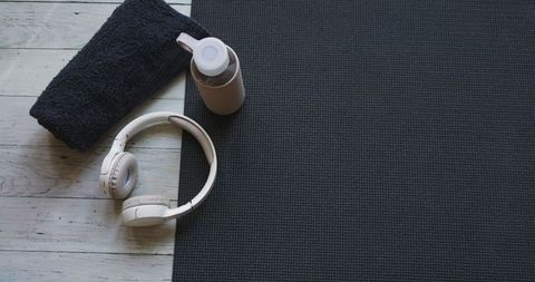 Minimalist home gym setup with yoga mat and accessories