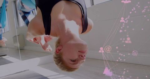 Inverted aerial yoga hammock training performing suspended inversion for flexibility core