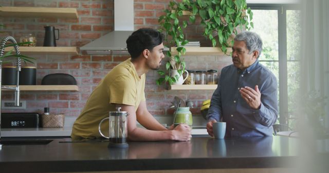 Father and Son Having Serious Conversation in Modern Kitchen - Download Free Stock Images Pikwizard.com