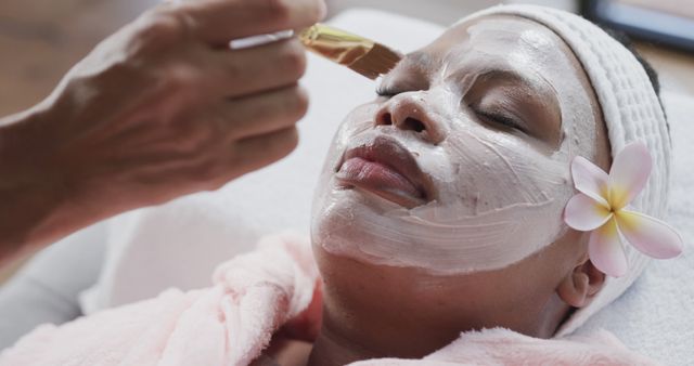 Woman Receiving Relaxing Spa Facial Treatment with Flower in Hair - Download Free Stock Images Pikwizard.com