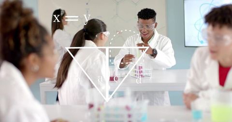 High school students conducting chemistry experiment transferring liquids in modern lab