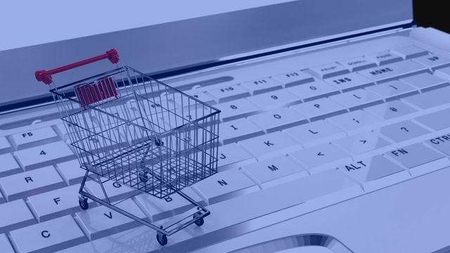 Small shopping cart displayed on laptop keyboard, symbolizing e-commerce and internet-based retail activities. Ideal for illustrating concepts of online shopping, digital transactions, e-commerce platforms, internet retail business, and technology integration. Useful for websites, blogs, marketing materials, and advertisements related to online retail and digital marketplace.