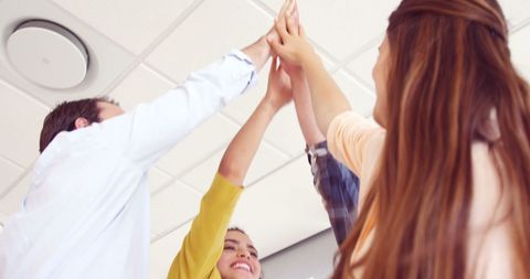 Diverse Team Celebrating Success with High-Five Gesture